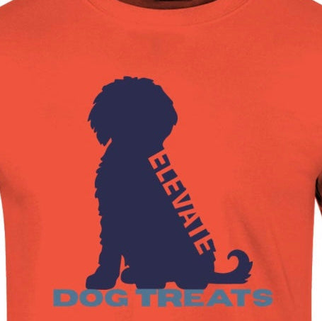 Orange shirt with blue dog design and negative space word "elevate" going along the spine of the dog who is in a sitting position. The words dog treats listed in blue beneath